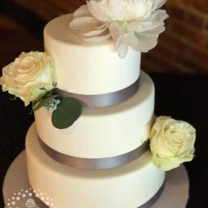 This beautifully simple cake was created by Sumthin' Sweet, using flowers from Schulz's Florist.  They both have our highest recommendations!